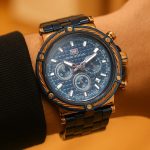Affordable watch on wrist focusing on the elegant details in blue and gold.