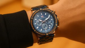 Affordable watch on wrist focusing on the elegant details in blue and gold.