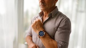 a man with a sharp sense of style, showing his watch from Obsyss