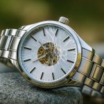 a broken watch on the ground showing that it is not a durable watch